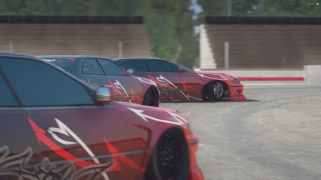 Two liveried cars in a tandem at the circuit