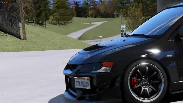 Black Lancer Evolution parked by a park path