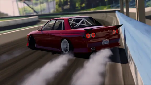 Red Skyline drifting along the wall with tyre smoke